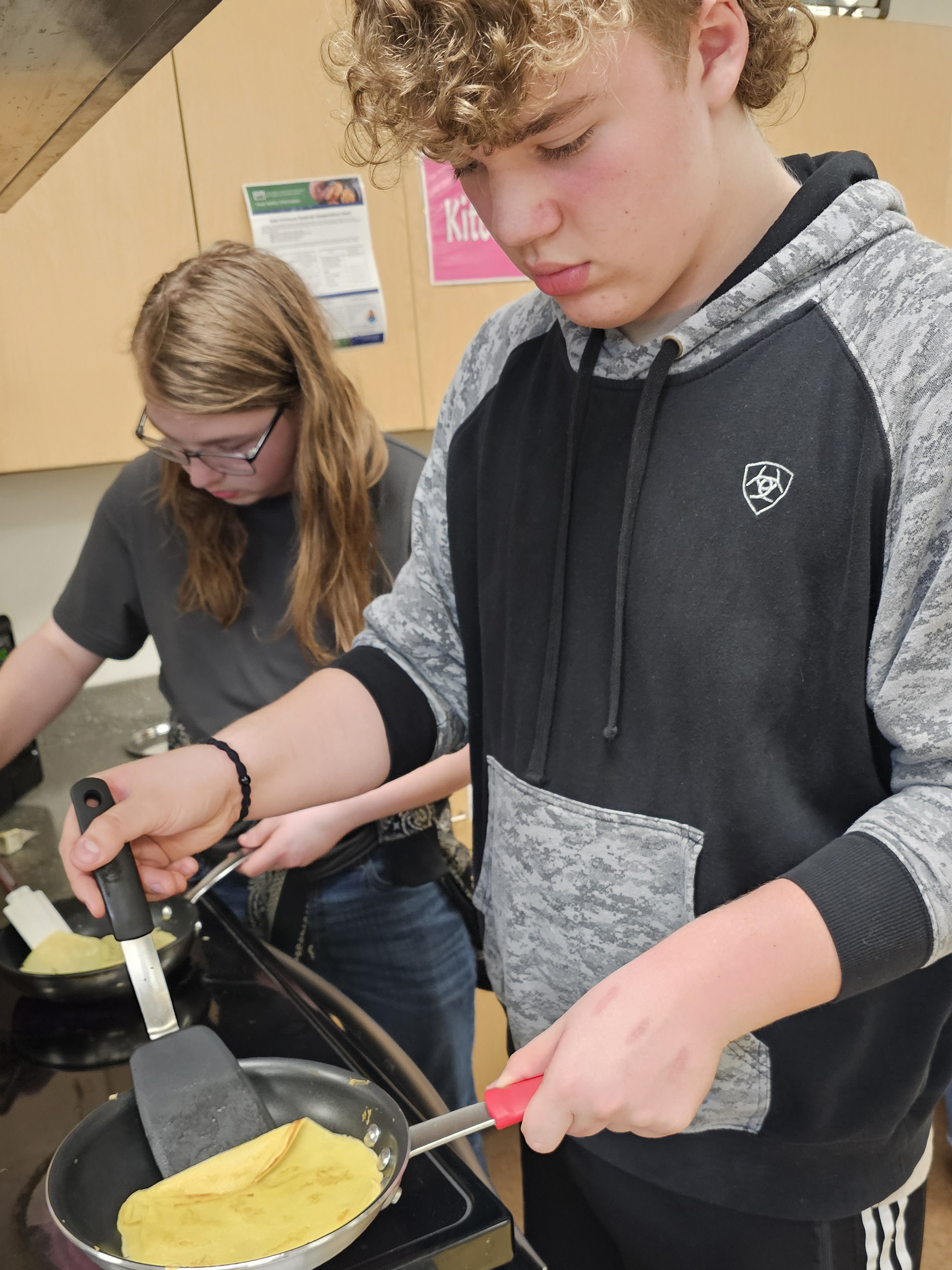 Students preparing blini for Maslenitsa