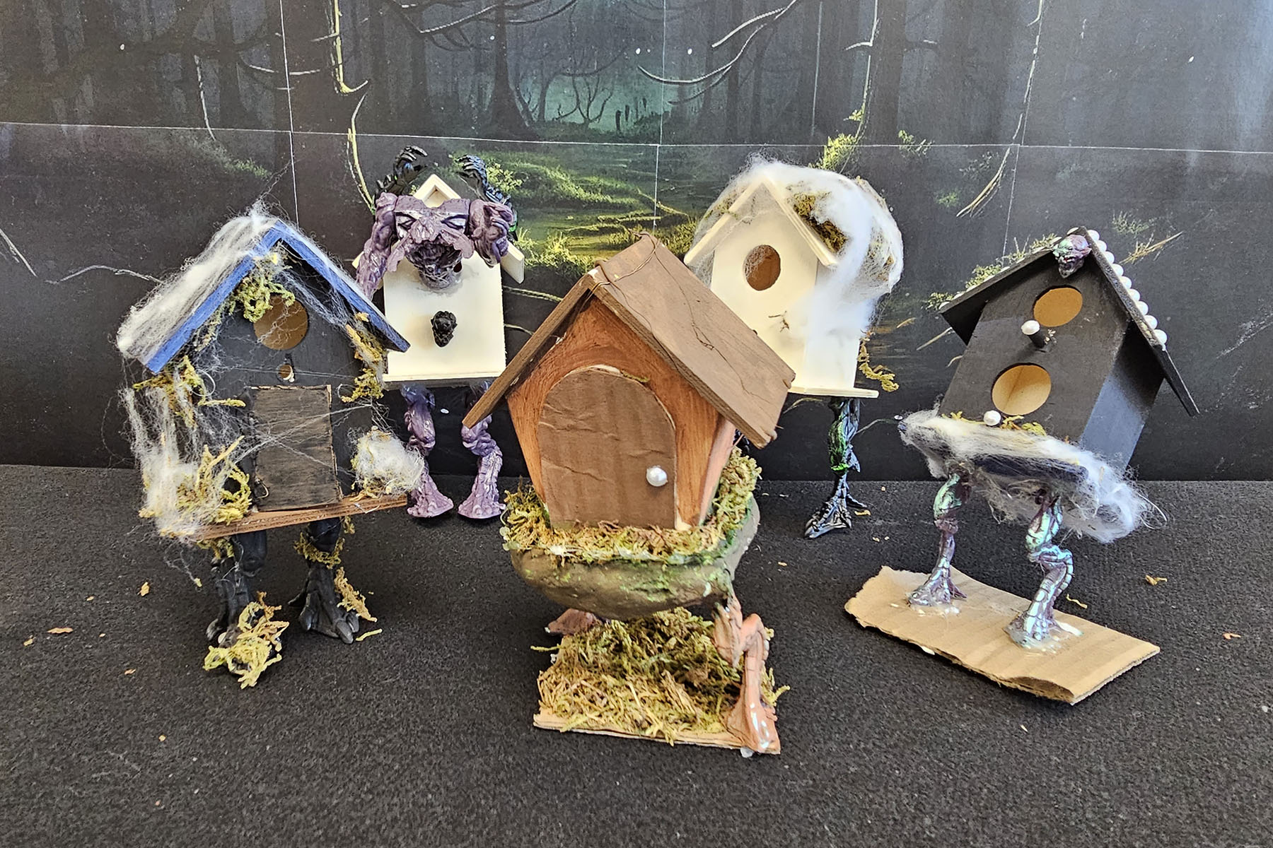 Student models of Baba Yaga's hut displayed together