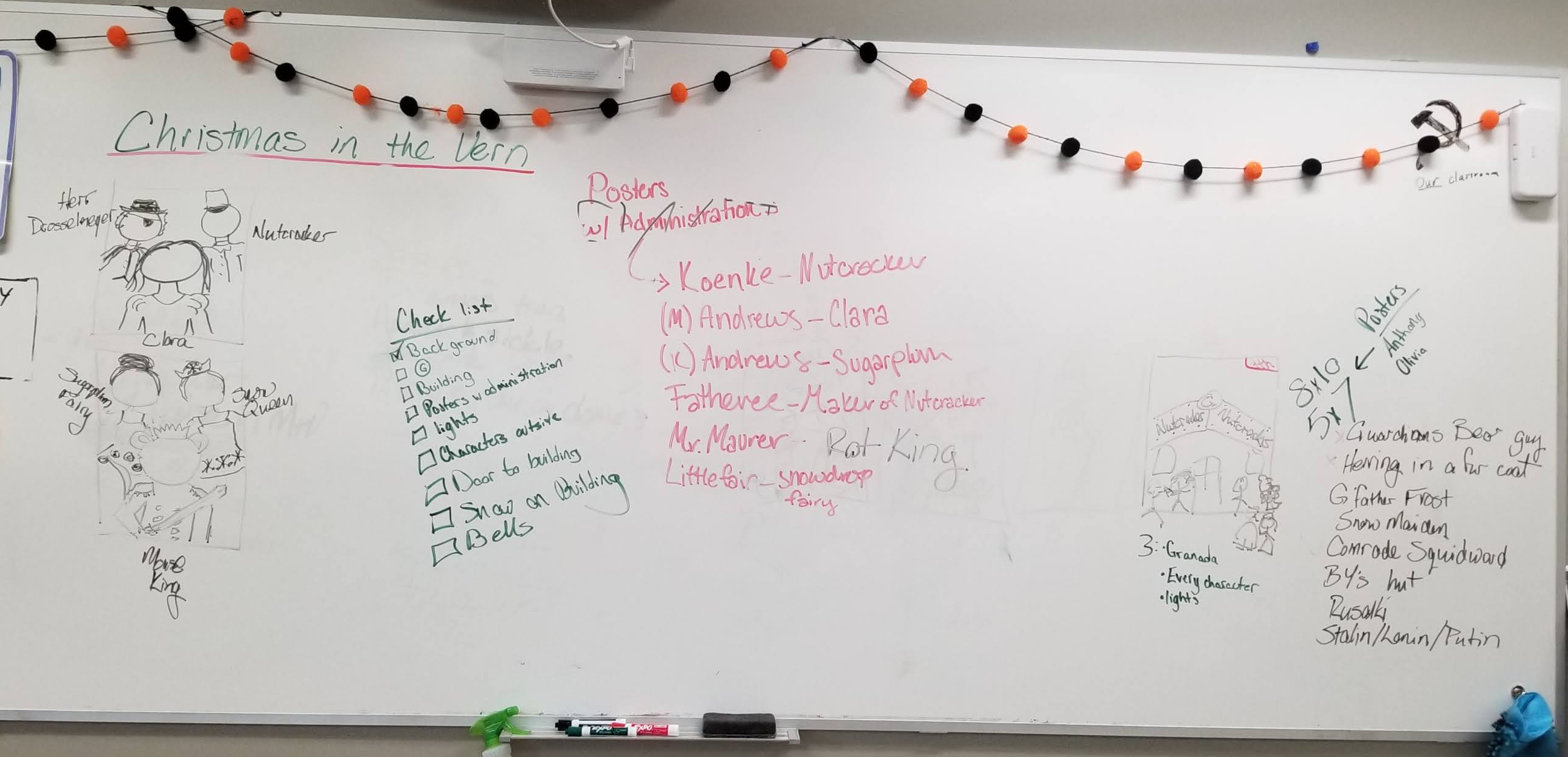 Student planning whiteboard for the door decorating project.